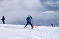 Ski rescuer is carrying an empty cradle down the mountain. concept of dangerous skating, freeride, rescue injured skier