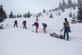 Ski rescuers pull a special sled akya in the mountains with the victim in the middle