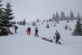 Ski rescuers pull a special sled akya in the mountains with the victim in the middle