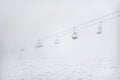 ski resort, cable car funicular in thick white fog. Royalty Free Stock Photo