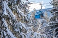 Ski resort, gondola ski lift cabin and pine trees Royalty Free Stock Photo