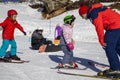 Ski resort, instructor is teaching a young girl to ski