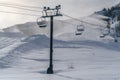 Ski resort with snowy ski lifts and snow cannons Royalty Free Stock Photo