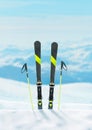 Ski and ski poles in the snow. Close-up vertical composition Royalty Free Stock Photo