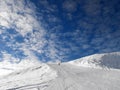 Ski slope on blue sky with clouds. Royalty Free Stock Photo