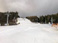 Ski slope with cableway and artificial snow without people