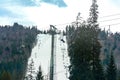Ski slope with lift on the background of evergreen Carpathian forest, Bukovel resort, Carpathians, Ukraine
