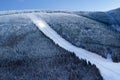 Ski slope resort panorama at evening night with a snowcat working, Stoh - Spindleruv Mlyn