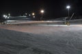Ski slope with rope tow at night.