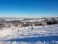 Ski slope with skiers, snowboarders and chairlifts Royalty Free Stock Photo