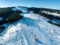 Ski slopes with skiers, snowboarders and chairlift in Poland Royalty Free Stock Photo