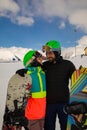 Ski and snowboard. Cool male and female snowboarders on Alps in winter holidays. Royalty Free Stock Photo