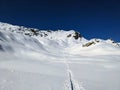 Ski tourers make a lonely track through the deep snow in the mountains above Davos. Ski mountaineering in the Swiss Alps