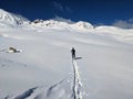 Ski tourers make a lonely track through the deep snow in the mountains above Davos. Ski mountaineering in the Swiss Alps