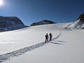 ski touring in deep snow on the glacier. Mountaineering on the Clariden in the Swiss mountains from Gemsfairenstock