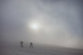 Ski touring on foggy mountain