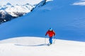 Ski touring man reaching the top at sunny day. Royalty Free Stock Photo