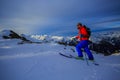 Ski touring man reaching the top at sunrise. Royalty Free Stock Photo