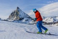 Ski touring man reaching the top in Swiss Alps. Royalty Free Stock Photo