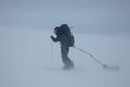 Ski touring man with sled in bad weather