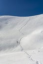 Ski touring - A skier while ascending a snowy slope to a mountain pass