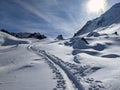 Ski touring track through the deep snow in a beautiful lonely mountain landscape. Ski tour slope. Skitour, Ski Tour