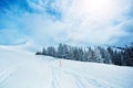 Ski track in the mountain range and valley covered with snow Royalty Free Stock Photo