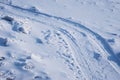 Ski track on the snow-covered ice of the river. Fragments of ice. Footprints after a snowfall. Glitter of snowflakes and