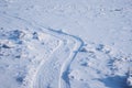 Ski track on the snow-covered ice of the river. Fragments of ice. Footprints after a snowfall. Glitter of snowflakes and