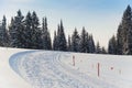 Ski track. Turn with flags in the winter forest.