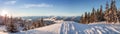 Ski tracks dropping off a ridge, looking out onto the mountains near Whistler, BC. Royalty Free Stock Photo