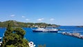 Skiathos, Greece - August 2023: Ferryboat approaching harbour at city of Skiathos at Skiathos island