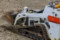 small excavator Bobcat at construction site Skid loader on construction site Royalty Free Stock Photo