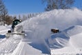 Skid steer blowing snow Royalty Free Stock Photo