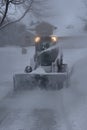 Skid steer blowing snow during a blizzard Royalty Free Stock Photo