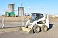 Skid-steer loader for loading and unloading works on city streets. ÃÂ¡ompact construction equipment for work in limited conditions Royalty Free Stock Photo