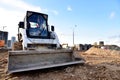 Skid-steer loader for loading and unloading works on city streets. ÃÂ¡ompact construction equipment for work in limited conditions Royalty Free Stock Photo