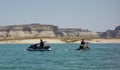 Skidooing past sandstone cliffs on lake powell