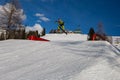 Skier in Action: Ski Jumping in the Mountain Snowpark Royalty Free Stock Photo