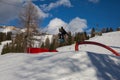 Skier In Action: Ski Jumping In The Mountain Snowpark