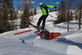 Skier In Action: Ski Jumping In The Mountain Snowpark