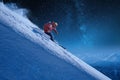 Skier with a backpack rides freeride on a snowy slope night skiing under a starry sky moonlight Royalty Free Stock Photo