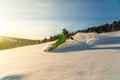 Skier carving in powder snow conditions and yellow sunset ambience Royalty Free Stock Photo