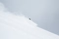 Skier disappearing in soft snow in backcountry ski turn through deep snow in Hokkaido, Japan Royalty Free Stock Photo