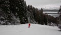 The skier dressed in red descends along the snowy slope Royalty Free Stock Photo