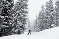 Skier on an empty ski road in the french alps, snowing Royalty Free Stock Photo