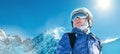 Skier female portrait in safe ski helmet and goggles with picturesque snowy Tatry mountains background. Active people winer