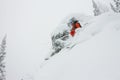 Skier freerider jumping from a snow ramp in the sun on a background of forest and mountains Royalty Free Stock Photo