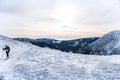 Skier in goggles and helmet walking on snow near firs Royalty Free Stock Photo