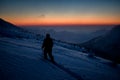 skier with hiking equipment walking at deep snow on mountain slope. Royalty Free Stock Photo